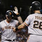 San Francisco Giants' Evan Longoria, left, celebrates his two-run home run against the Arizona Diamondbacks with Buster Posey (28) during the sixth inning of a baseball game Wednesday, April 18, 2018, in Phoenix. (AP Photo/Ross D. Franklin)