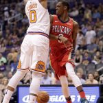 New Orleans Pelicans guard Rajon Rondo (9) passes the ball as Phoenix Suns forward Marquese Chriss (0) defends during the first half of an NBA basketball game Friday, April 6, 2018, in Phoenix. (AP Photo/Matt York)