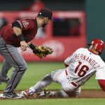 Philadelphia Phillies' Cesar Hernandez (16) is tagged out on a attempted steal by Arizona Diamondbacks' Daniel Descalso during the fifth inning of a baseball game, Wednesday, April 25, 2018, in Philadelphia. (AP Photo/Derik Hamilton)