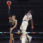 Michigan's Jordan Poole (2) shoots against Villanova's Eric Paschall (4) during the first half in the championship game of the Final Four NCAA college basketball tournament, Monday, April 2, 2018, in San Antonio. (AP Photo/Chris Steppig, NCAA Photos Pool)
