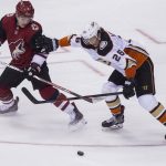 Phoenix Coyotes' Max Domi, left, gets shoved away from the puck by the Anaheim Ducks' Brandon Montour during the third period of an NHL hockey game Saturday, April 7, 2018, in Glendale, Ariz. The Ducks won 3-0. (AP Photo/Darryl Webb)