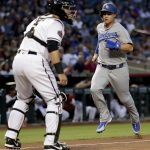 Los Angeles Dodgers' Joc Pederson scores on a base hit by teammate Corey Seager as Arizona Diamondbacks catcher Alex Avila waits for the throw during the first inning of a baseball game Monday, April 2, 2018, in Phoenix. (AP Photo/Matt York)