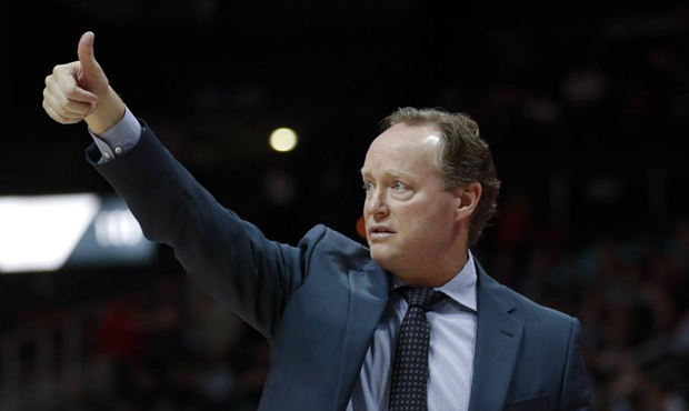 Atlanta Hawks head coach Mike Budenholzer signals to his team during the first half of an NBA baske...