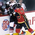 Arizona Coyotes' Luke Schenn, left, is hit by Calgary Flames' Micheal Ferland during first period NHL hockey action in Calgary, Alberta, Tuesday, April 3, 2018. (Larry MacDougal/The Canadian Press via AP)
