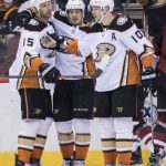 Anaheim Ducks' Rickard Rakell, middle, celebrates with teammates Ryan Getzlaf, left, and Corey Perry after scoring against the Phoenix Coyotes during the second period of an NHL hockey game Saturday, April 7, 2018, in Glendale, Ariz. (AP Photo/Darryl Webb