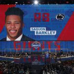 Commissioner Roger Goodell presents Penn State's Saquon Barkley with his New York Giants jersey during the first round of the NFL football draft, Thursday, April 26, 2018, in Arlington, Texas. (AP Photo/David J. Phillip)