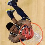 Michigan's Charles Matthews dunks during the first half in the championship game of the Final Four NCAA college basketball tournament against Villanova, Monday, April 2, 2018, in San Antonio. (AP Photo/David J. Phillip)