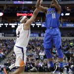 Phoenix Suns' Jared Dudley (3) defends as Dallas Mavericks guard Yogi Ferrell (11) attempts a 3-point basket in the first half of a NBA basketball game in Dallas, Tuesday, April 10, 2018. (AP Photo/Tony Gutierrez)