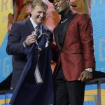 Commissioner Roger Goodell, left, presents Florida State's Derwin James with his Los Angeles Chargers jersey during the first round of the NFL football draft, Thursday, April 26, 2018, in Arlington, Texas. (AP Photo/David J. Phillip)