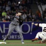 Arizona Diamondbacks shortstop Nick Ahmed, left, completes a double play over San Francisco Giants' Buster Posey (28) on a ground ball from Brandon Crawford during the second inning of a baseball game Monday, April 9, 2018, in San Francisco. (AP Photo/Marcio Jose Sanchez)