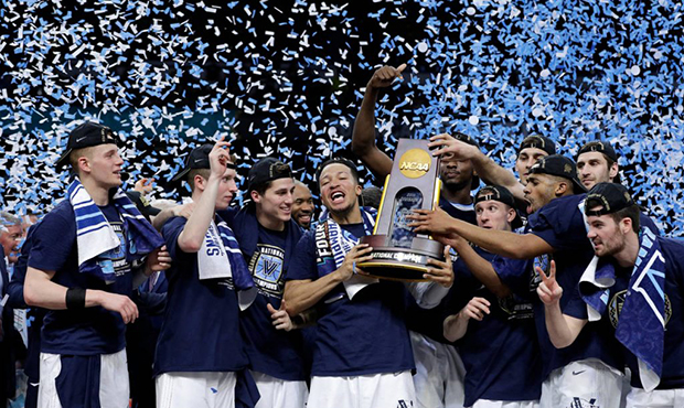 Villanova players celebrate with the trophy after beating Michigan 79-62 in the championship game o...