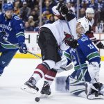 Arizona Coyotes' Richard Panik, center, of Slovakia, looks for the puck after it got caught in his skates in front of Vancouver Canucks goalie Jacob Markstrom, right, of Sweden, as Alexander Edler, left, also of Sweden, watches during the first period of an NHL hockey game Thursday, April 5, 2018, in Vancouver, British Columbia. (Darryl Dyck/The Canadian Press via AP)