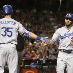 Los Angeles Dodgers' Chris Taylor (3) celebrates his run scored against the Arizona Diamondbacks with Cody Bellinger (35) during the sixth inning of a baseball game Monday, April 30, 2018, in Phoenix. (AP Photo/Ross D. Franklin)