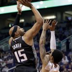 Sacramento Kings guard Vince Carter (15) shoots over Phoenix Suns guard Tyler Ulis (8) during the first half of an NBA basketball game Tuesday, April 3, 2018, in Phoenix. (AP Photo/Matt York)