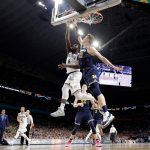Villanova's Eric Paschall (4) shoots against Michigan's Moritz Wagner (13) during the second half in the championship game of the Final Four NCAA college basketball tournament, Monday, April 2, 2018, in San Antonio. (AP Photo/David J. Phillip)