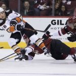 Anaheim Ducks' Brandon Montour slaps the puck down the ice away from the Phoenix Coyotes' Christian Fischer and Brendan Perlini, right, during the first period of an NHL hockey game Saturday, April. 7, 2018, in Glendale, Ariz. (AP Photo/Darryl Webb)