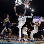 Villanova's Eric Paschall (4) shoots over Michigan's Zavier Simpson during the second half in the championship game of the Final Four NCAA college basketball tournament, Monday, April 2, 2018, in San Antonio. (AP Photo/Eric Gay)