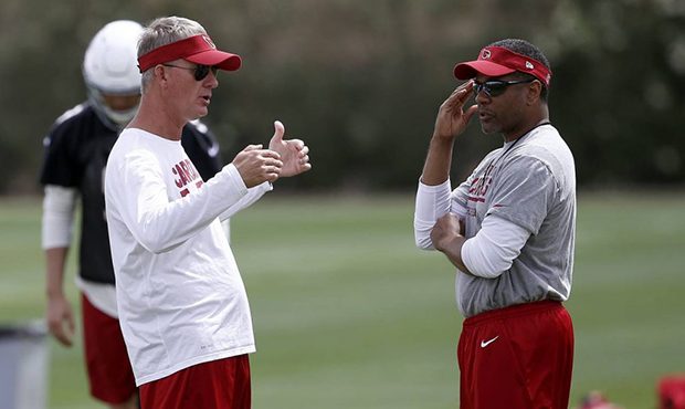 Arizona Cardinals head coach Steve Wilks, right, talks with offensive coordinator Mike McCoy, left,...