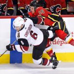 Arizona Coyotes'Jakob Chychrun (left) collides with Calgary Flames' Spencer Foo during first period NHL hockey action in Calgary, Alberta, Tuesday, April 3, 2018. (Larry MacDougal/The Canadian Press via AP)