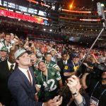 USC's Sam Darnold takes a selfie as he poses with fans after being elected by the New York Jets during the first round of the NFL football draft, Thursday, April 26, 2018, in Arlington, Texas. (AP Photo/Michael Ainsworth)