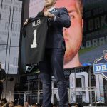 UCLA's Kolton Miller poses with his Oakland Raiders jersey after being selected by the team during the first round of the NFL football draft, Thursday, April 26, 2018, in Arlington, Texas. (AP Photo/David J. Phillip)