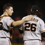 San Francisco Giants catcher Buster Posey, left, congratulates relief pitcher Cory Gearrin after the final out in the 10th inning of a baseball game against the Arizona Diamondbacks on Wednesday, April 18, 2018, in Phoenix. The Giants won 4-3. (AP Photo/Ross D. Franklin)