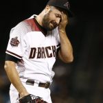 Arizona Diamondbacks starting pitcher Robbie Ray wipes sweat from his forehead during the third inning of the team's baseball game against the San Francisco Giants on Wednesday, April 18, 2018, in Phoenix. (AP Photo/Ross D. Franklin)