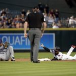 Arizona Diamondbacks' Jarrod Dyson, right, signals his dugout to challenge the out call after stealing second as San Diego Padres Carlos Asuaje, left, gets up after making the tag during the first inning of a baseball game Friday, April 20, 2018, in Phoenix. The play was overturned and Dyson was ruled safe on the steal. (AP Photo/Matt York)