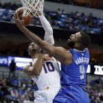 Phoenix Suns guard Shaquille Harrison defends as Dallas Mavericks' Aaron Harrison (9) attempts a shot in the first half half of a NBA basketball game in Dallas, Tuesday, April 10, 2018. (AP Photo/Tony Gutierrez)