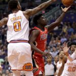 New Orleans Pelicans guard Jrue Holiday (11) has his shot blocked by Phoenix Suns forward Marquese Chriss (0) during the first half of an NBA basketball game Friday, April 6, 2018, in Phoenix. (AP Photo/Matt York)