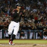 Arizona Diamondbacks' Deven Marrero applauds as he scores a run against the San Diego Padres during the second inning of a baseball game Saturday, April 21, 2018, in Phoenix. (AP Photo/Ross D. Franklin)