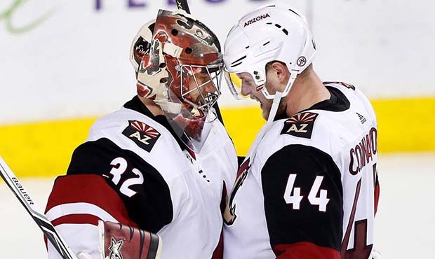 Arizona Coyotes goalie Antti Raanta, from Finland, and teammate Kevin Connauton celebrate the Coyot...