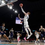 Villanova's Donte DiVincenzo (10) shoots against =Michigan's Muhammad-Ali Abdur-Rahkman during the first half in the championship game of the Final Four NCAA college basketball tournament, Monday, April 2, 2018, in San Antonio. (AP Photo/Eric Gay)