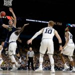 Michigan forward Moritz Wagner (13) drives to the basket over Villanova forward Eric Paschall during the second half in the championship game of the Final Four NCAA college basketball tournament, Monday, April 2, 2018, in San Antonio. (AP Photo/Eric Gay)