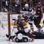 Anaheim Ducks' Adam Henrique falls on his back after scoring against Phoenix Coyotes' Antti Rannta during the first period of an NHL hockey game Saturday, April. 7, 2018, in Glendale, Ariz. (AP Photo/Darryl Webb)