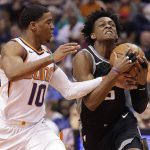 Sacramento Kings guard De'Aaron Fox (5) drives on Phoenix Suns guard Shaquille Harrison (10) during the first half of an NBA basketball game Tuesday, April 3, 2018, in Phoenix. (AP Photo/Matt York)