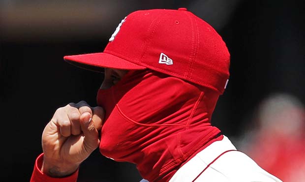 St. Louis Cardinals first baseman Jose Martinez blows on his hand to keep warm during the first inn...