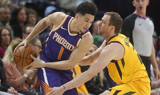 Utah Jazz forward Joe Ingles, right, guards Phoenix Suns guard Devin Booker (1) during the first ha...