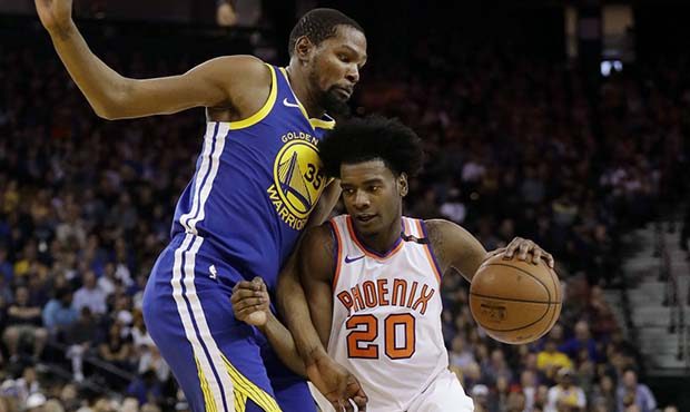 Phoenix Suns' Josh Jackson is defended by Golden State Warriors' Kevin Durant during the second hal...
