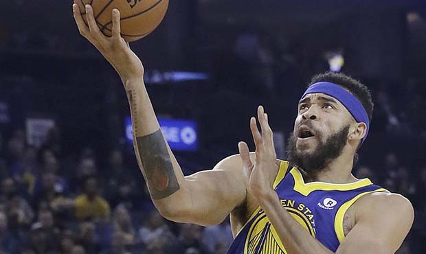 Golden State Warriors center JaVale McGee, right, shoots against Utah Jazz guard Donovan Mitchell (...