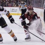 Arizona Coyotes' Clayton Keller, right, throws up some ice as he protects the puck from Anaheim Ducks' Josh Montour during the second period of an NHL hockey game Saturday, April 7, 2018, in Glendale, Ariz. (AP Photo/Darryl Webb