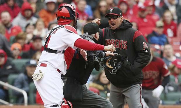 Arizona Diamondbacks manager Torey Lovullo gestures at St. Louis Cardinals catcher Yadier Molina as...