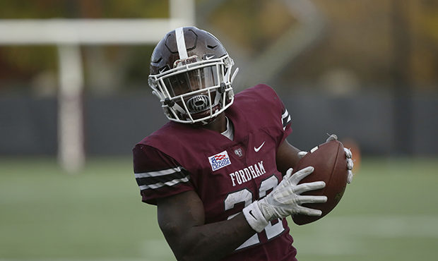 Fordham's Chase Edmonds #22 runs the ball up the field against Holy Cross during an NCAA college fo...