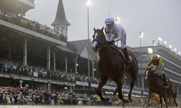 Mike Smith rides Justify to victory during the 144th running of the Kentucky Derby horse race at Ch...