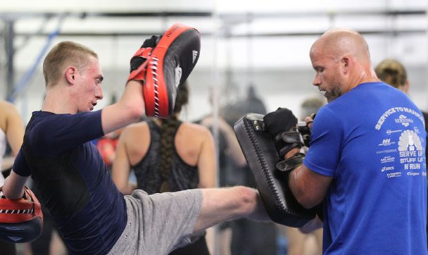 Students at Arizona Combat Sports in Tempe practice kicking exercises. The growing popularity of co...