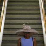 A woman walks down a grandstand staircase during the 143rd Preakness Stakes horse race at Pimlico race course, Saturday, May 19, 2018, in Baltimore. (AP Photo/Patrick Semansky)