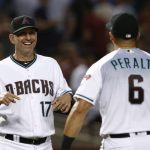 Arizona Diamondbacks manager Torey Lovullo (17) smiles as he and David Peralta celebrate the team's 2-1 win over the Milwaukee Brewers in a baseball game Tuesday, May 15, 2018, in Phoenix. (AP Photo/Ross D. Franklin)