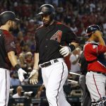 Arizona Diamondbacks' Paul Goldschmidt, center, celebrates his run scored with Steven Souza Jr. (28) as Washington Nationals catcher Pedro Severino, right, pauses at home plate during the third inning of a baseball game Saturday, May 12, 2018, in Phoenix. (AP Photo/Ross D. Franklin)