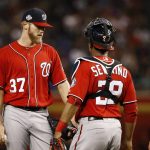 Washington Nationals starting pitcher Stephen Strasburg (37) gets a visit from pitching coach Derek Lilliquist, right, and catcher Pedro Severino, middle, during the first inning of a baseball game against the Arizona Diamondbacks Saturday, May 12, 2018, in Phoenix. (AP Photo/Ross D. Franklin)