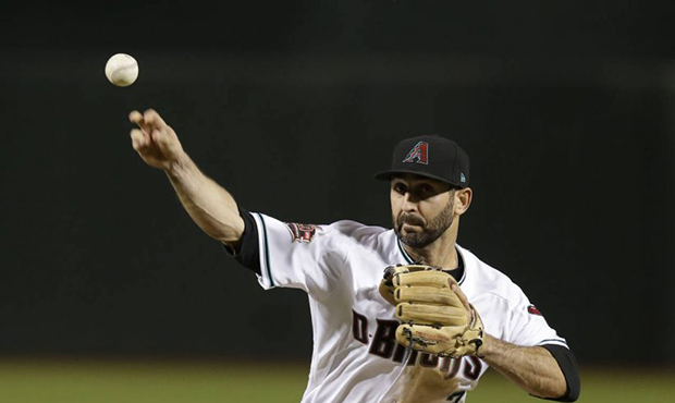 Infielder Daniel Descalso pitches for D-backs in ninth inning
